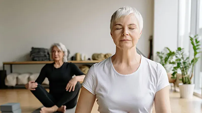 Woman practising calm meditation, representing menopause and HRT support